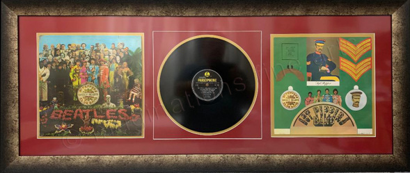 Beatles album showing front of sleeve and poster with vinyl record in centre
